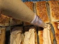 Put the cream in a pastry bag and divide evenly on...
