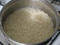 Reduce the heat, cover the rice and cook slowly...