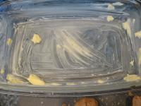 Grease a deep baking dish roughly with butter....