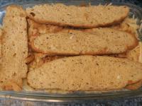 Cover with another layer of soaked rolls, add...
