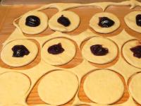 Work with dough in parts. Roll the dough on a...