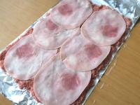 Put slices of ham on the meat ......