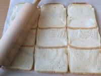 Lay the toast bread on baking paper so that it...