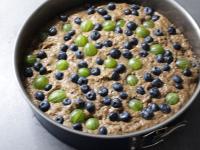 Decorate the surface with fruit and press it with...