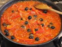 Add broth to the sauce and season. Add olives....