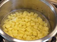 Brush potatoes, cut into a smaller cubes and put...