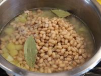 Strain the canned beans and rinse on a sieve under...