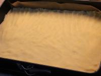 Roll the dough out to the size of a baking sheet...