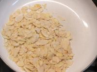 Roast almond flakes in a pan....