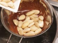 Melt the chocolate in the water bath and coat the...