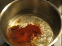 Fry flour in oil, add the peppers and pour water...