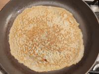 Pour a small ladle of batter evenly onto a...
